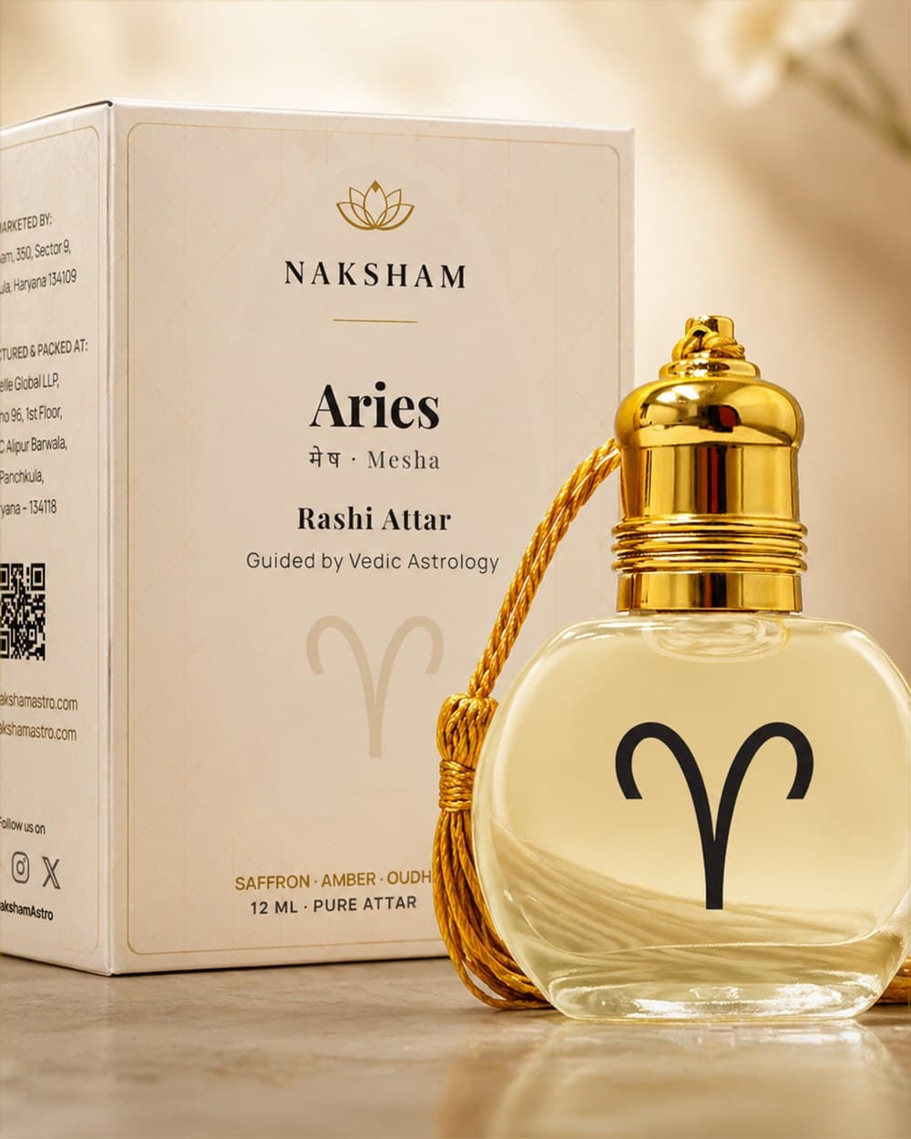 Naksham Rashi attar bottle, alcohol-free single-origin fragrance, captured on cream paper.